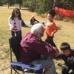 2017 sitting grandpa volunteer playing with kids